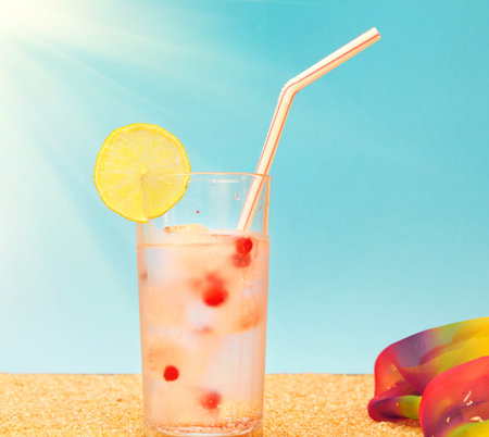 Fresh tropical cocktail on the sand under the sun