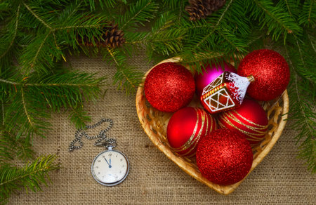 Christmas decorations and fir branches on canvas background