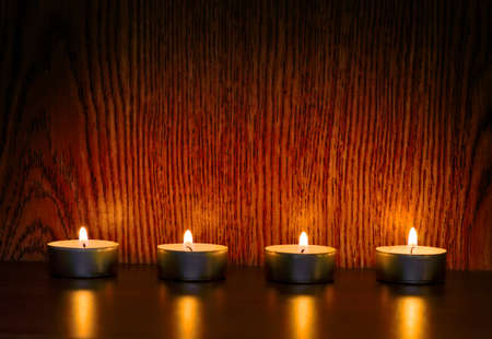 Christmas candles on a wooden shelfの写真素材