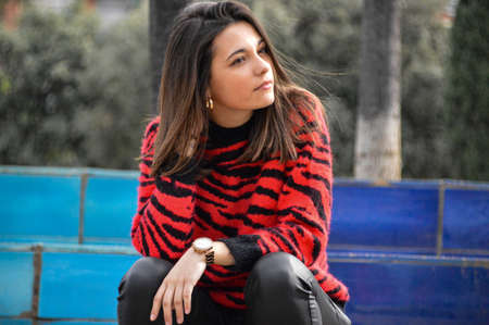 Young girl waiting in the parck with a hand watchの写真素材