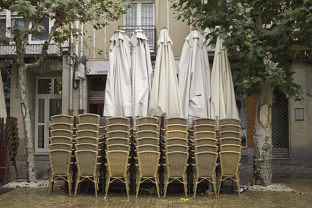 Terrace bar with chairs and parasols, season autumn, hospitality
