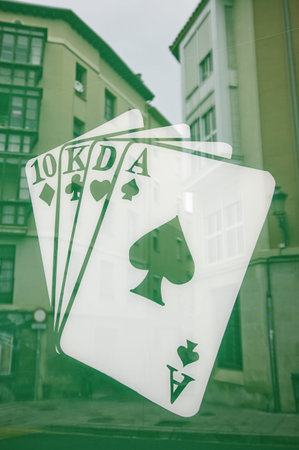 Poker deck painted on glass, with reflection of the city