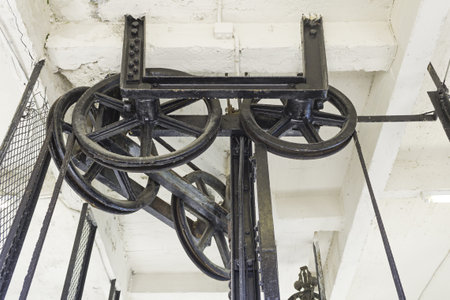 Gear inside old elevator in building