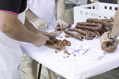 People cutting sausage festivals, food and workの写真素材