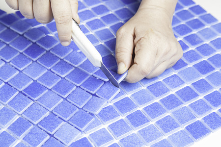 Manipulating tiles for pools, worker workmanの写真素材