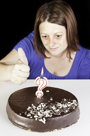 Celebration birthday girl with chocolate cake and candlesの写真素材