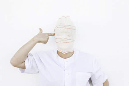 Mental patient pistol bandaged by joiningの写真素材