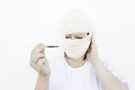 Sick with syringe bandaged, disease and medicalの写真素材