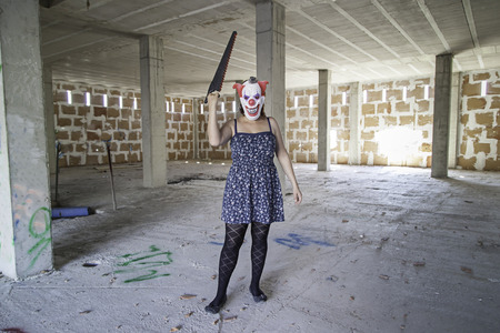 Crazy clown with saw, murderer and halloweenの写真素材
