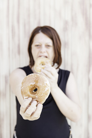 Girl with sugary donuts in urban street foodの写真素材