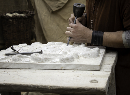 Carving stone in a traditional way, craftsmanship detail, shaping the stoneの写真素材