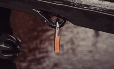 Padlock hanging on bridge, symbol of love, union