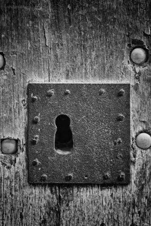 Oxidized iron lock on old wooden door, constructionの写真素材