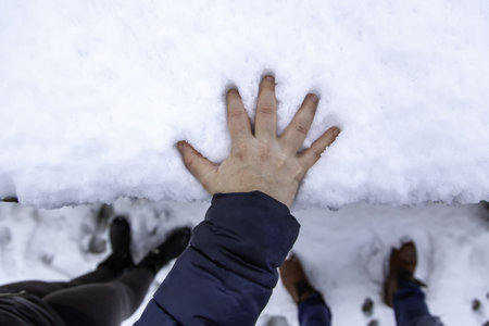 Hand resting on snow, cold and winter, Christmasの写真素材