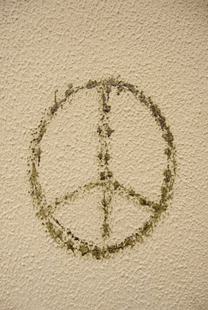 Detail of symbol of peace and harmony painted a wall in the street