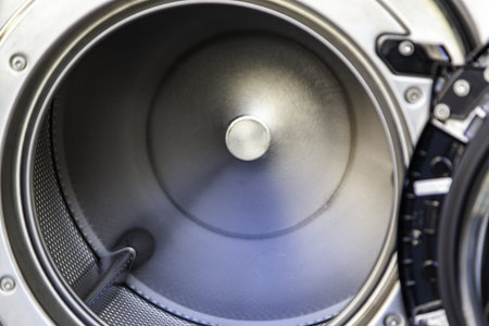 Detail of the interior of a public washing machine in the city, industrial cleaning