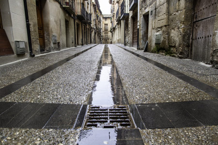Wet stone street in old town, construction and architectureの写真素材