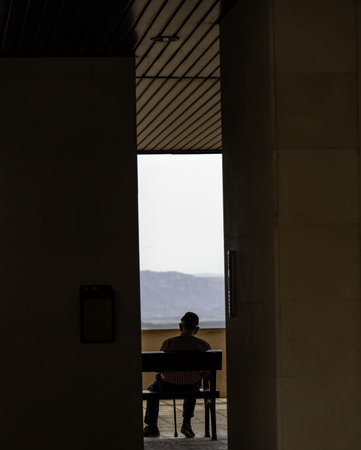 Detail of grandfather resting on a bench in the streetの写真素材