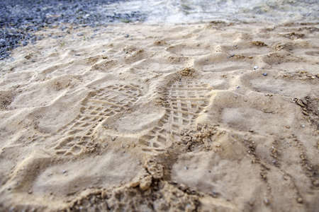 Shoe sole mark detail in the sandの写真素材