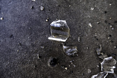 Detail of broken glass on the ground, vandalism and crime