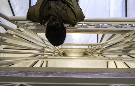 Detail of woman looking at the top of stairsの写真素材