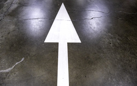 Detail of direction arrow for vehicles in a parking lot