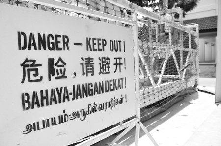 Danger sign in four languages at construction site