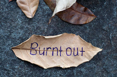 Burnt Out written on a leafの写真素材