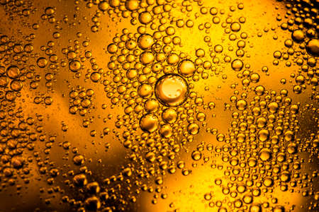 yellow beer oil abstract colorful organic bubbles macro pattern textureの写真素材