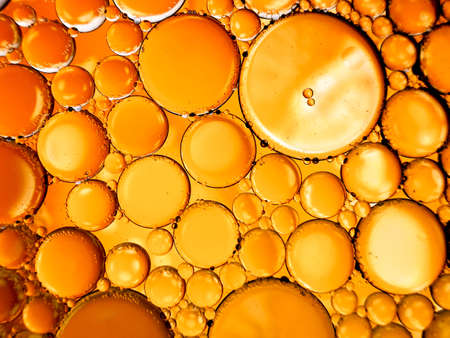 gold yellow beer oil organic abstract texture pattern bubbles macroの写真素材