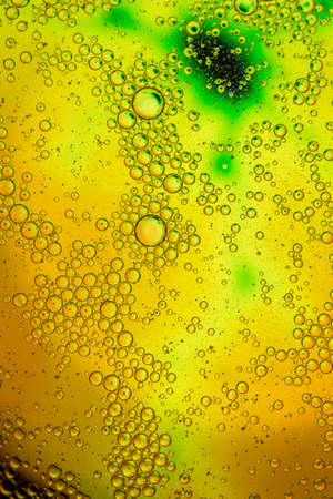 yellow beer oil abstract colorful organic bubbles macro pattern textureの写真素材