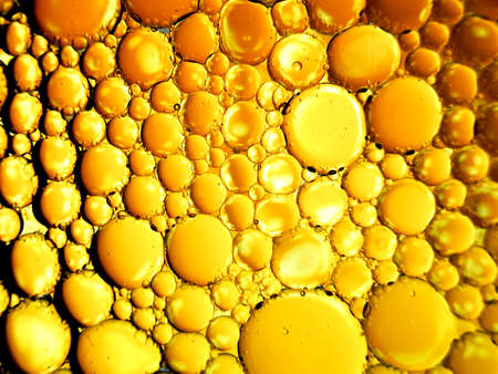 gold yellow beer oil organic abstract texture pattern bubbles macroの写真素材