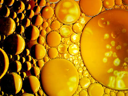 gold yellow beer oil organic abstract texture pattern bubbles macroの写真素材