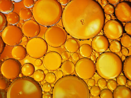gold yellow beer oil organic abstract texture pattern bubbles macroの写真素材