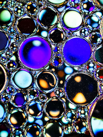 neon rainbow colorful oil bubbles abstract textures for backgroundsの写真素材