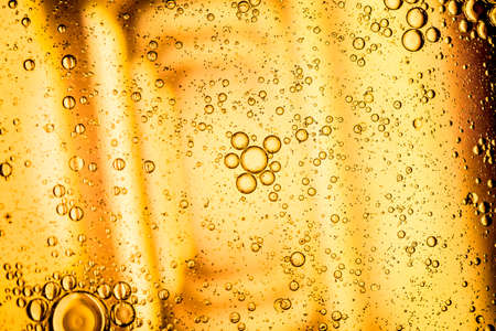 yellow beer oil abstract colorful organic bubbles macro pattern textureの写真素材