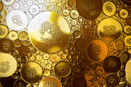 yellow beer oil abstract colorful organic bubbles macro pattern textureの写真素材