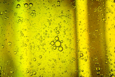 yellow beer oil abstract colorful organic bubbles macro pattern textureの写真素材