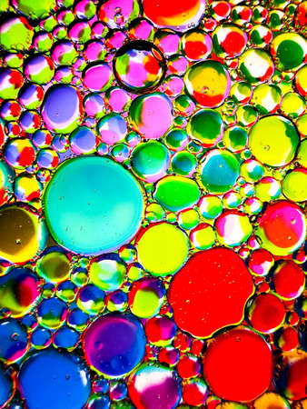 neon rainbow colorful oil bubbles abstract textures for backgroundsの写真素材