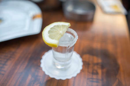 shot glass filled with tequila service with lemon and salt focused open air pub barの写真素材