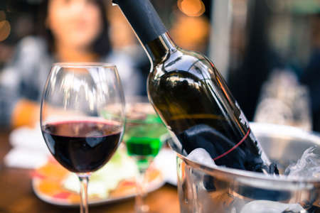 red wine on open air restaurant cafe romantic joyful young adults tableの写真素材