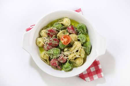 basil sauced pasta with vegetables top view isolated backgroundの写真素材