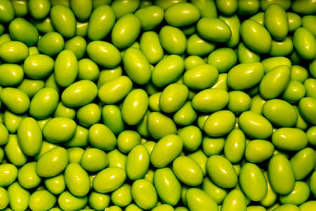 neon green candies sugar coated chocolatesの写真素材