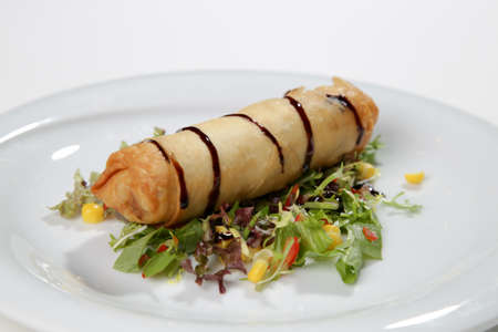 spring rolls chinese snack white backgroundの写真素材