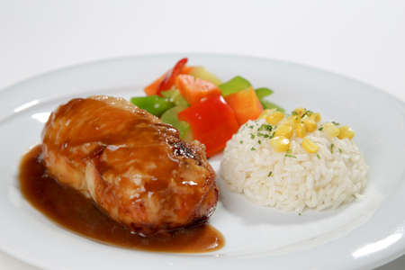 barbeque sauced chicken roll with side dish white backgroundの写真素材