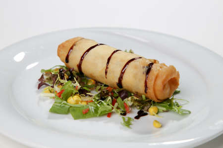 spring rolls chinese snack white backgroundの写真素材