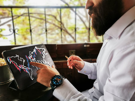 Bearded young businessman adult with smart watch using pro tablet touch screen to connect world and...