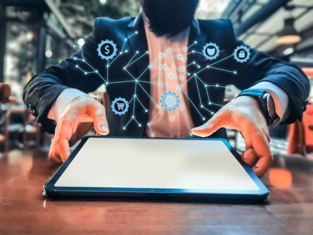young adult with beard rich businessman who has smart watch using his pro tablet on the table and...