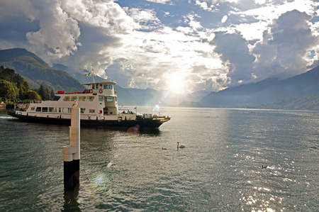 View of Lake Como on a cloudy day with boat in the foreground in Bellagio, a charming tourist village between the lake and the mountains of the Alps. Located in the Lombardy region, northern Italyの写真素材