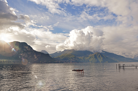 View of Lake Como in a cloudy day with sunshine in Bellagio, a charming tourist village between the lake and the mountains of the Alps. Located in the Lombardy region, northern Italyの写真素材